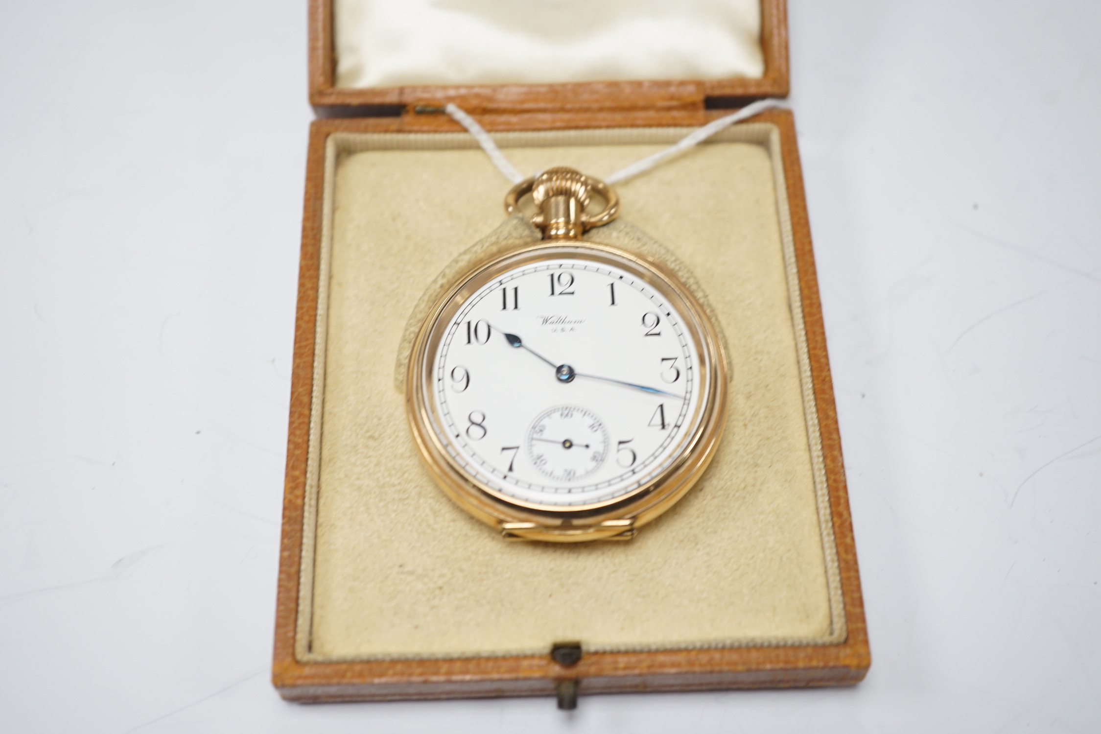 A Waltham gold plated open face keyless pocket watch, with Roman dial and subsidiary seconds.